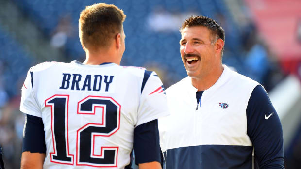 New England Patriots quarterback Tom Brady (12) talks with Tennessee Titans head coach Mike Vrabel before the preseason game at Nissan Stadium.